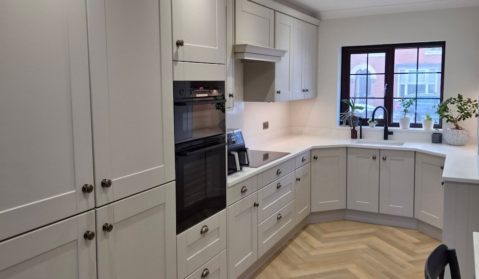 Light grey shaker kitchen with quartz worktops and herringbone flooring