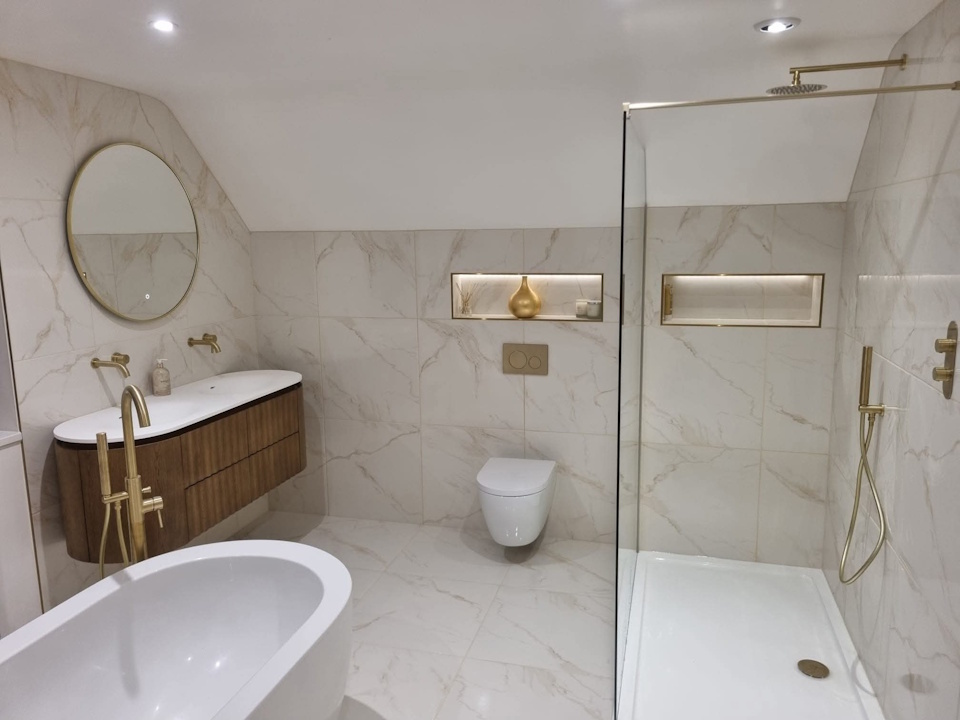 Marble-effect bathroom with freestanding bath, walk-in shower and brushed brass fittings